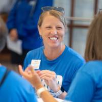 Volunteers talking while they sit at table